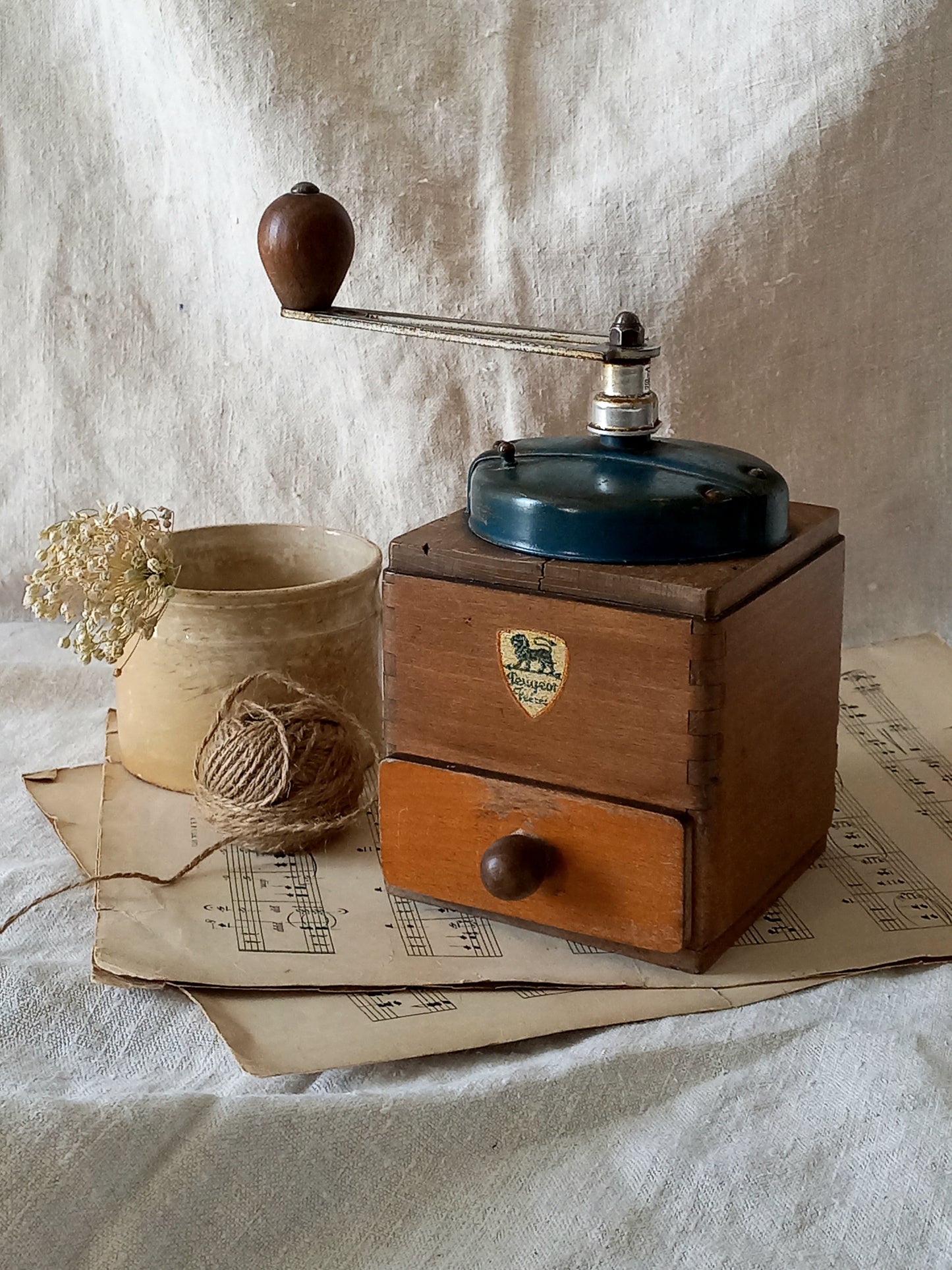 Vintage wooden coffee grinder on a textured surface with a rustic background