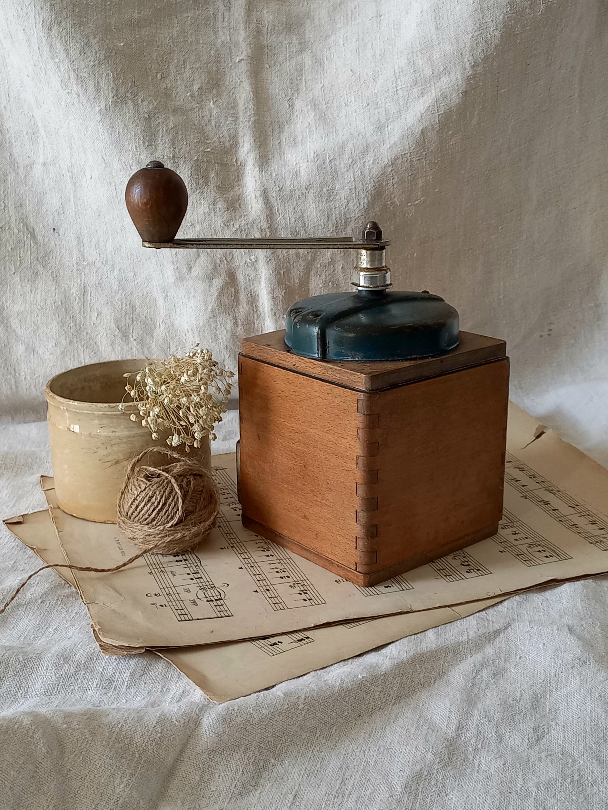 Vintage wooden coffee grinder on a textured surface with a rustic background