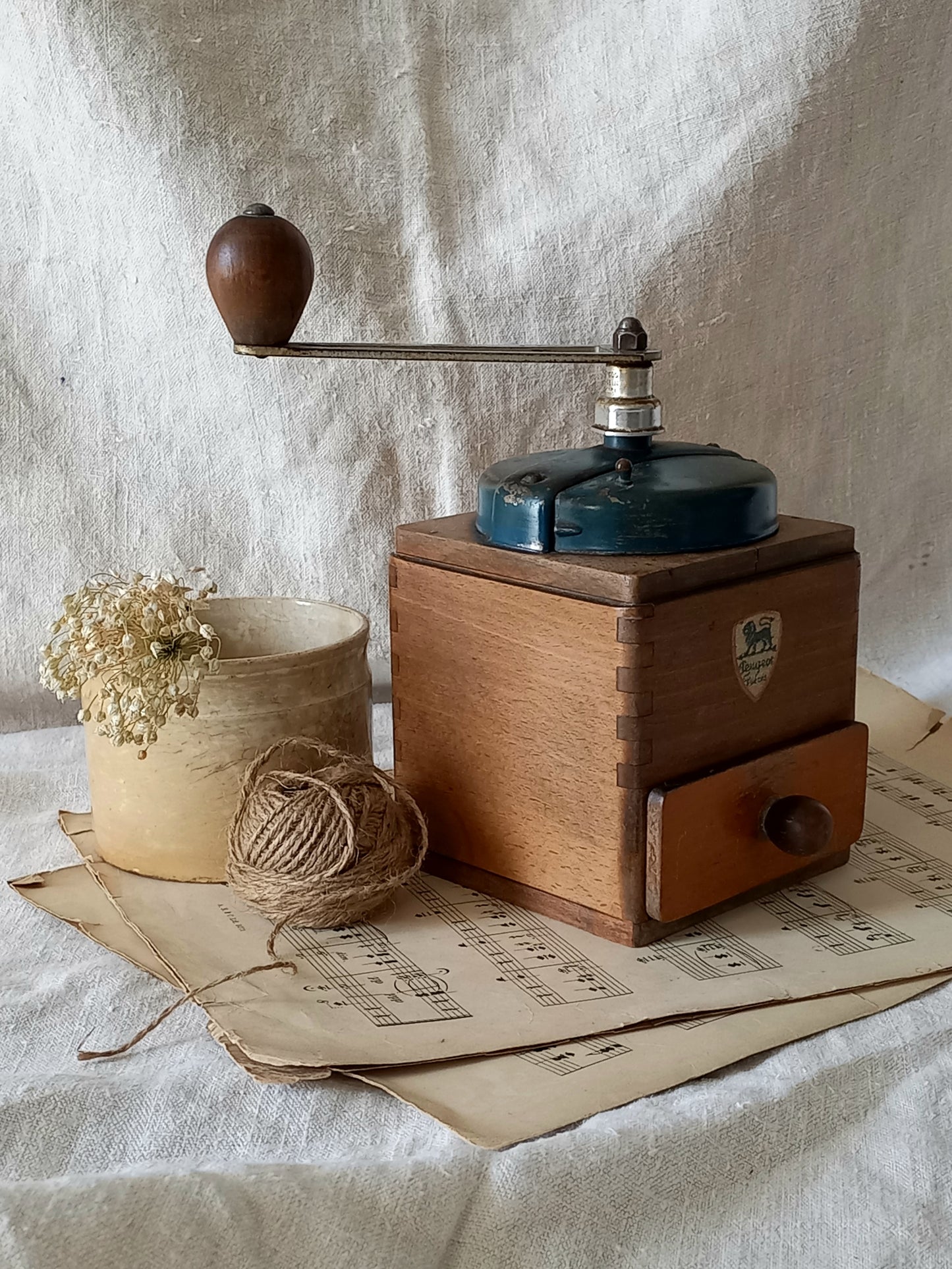 Vintage wooden coffee grinder on a textured surface with a rustic background