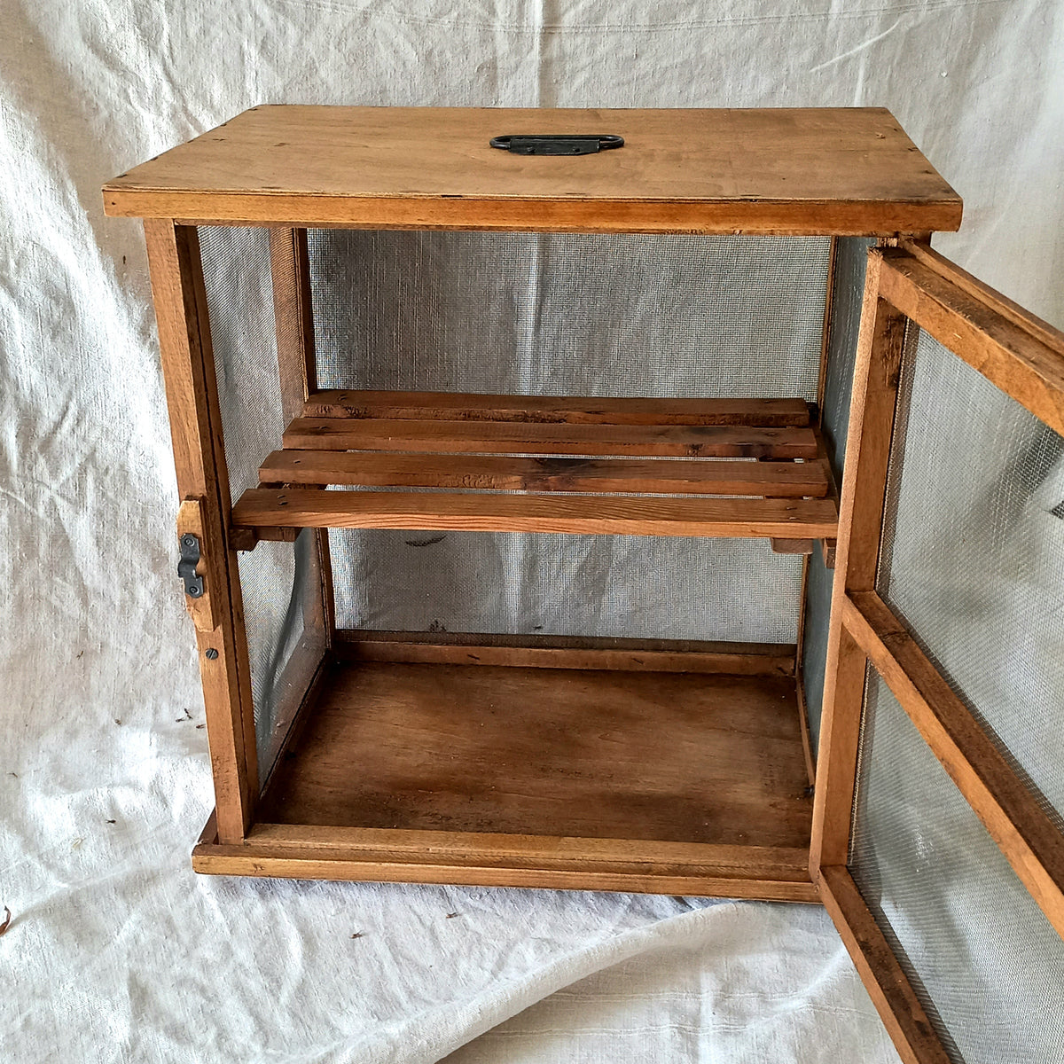 Wooden shelf with two shelves on a white fabric background