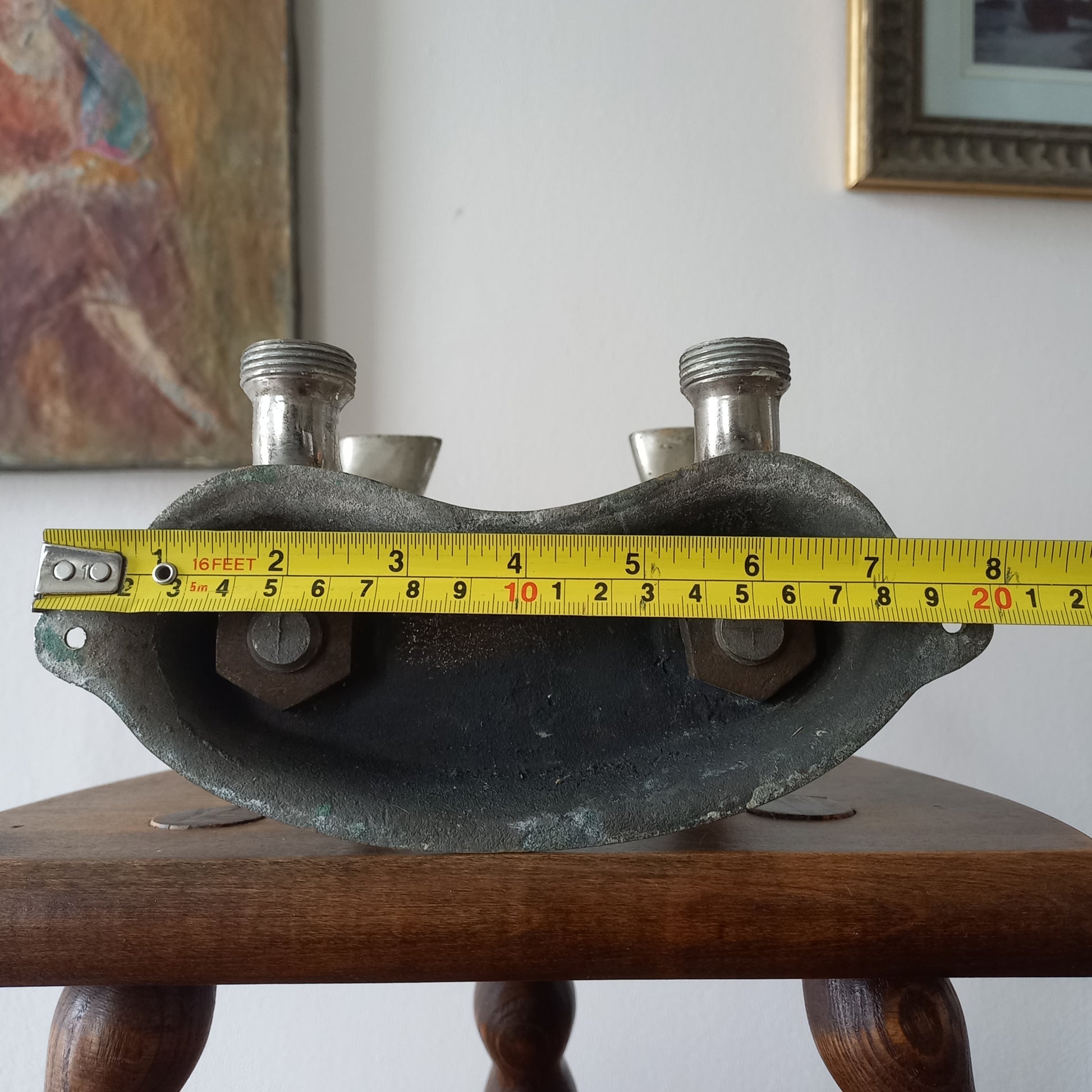 Close-up of a vintage metal faucet on a wooden background with visible wear and tear 