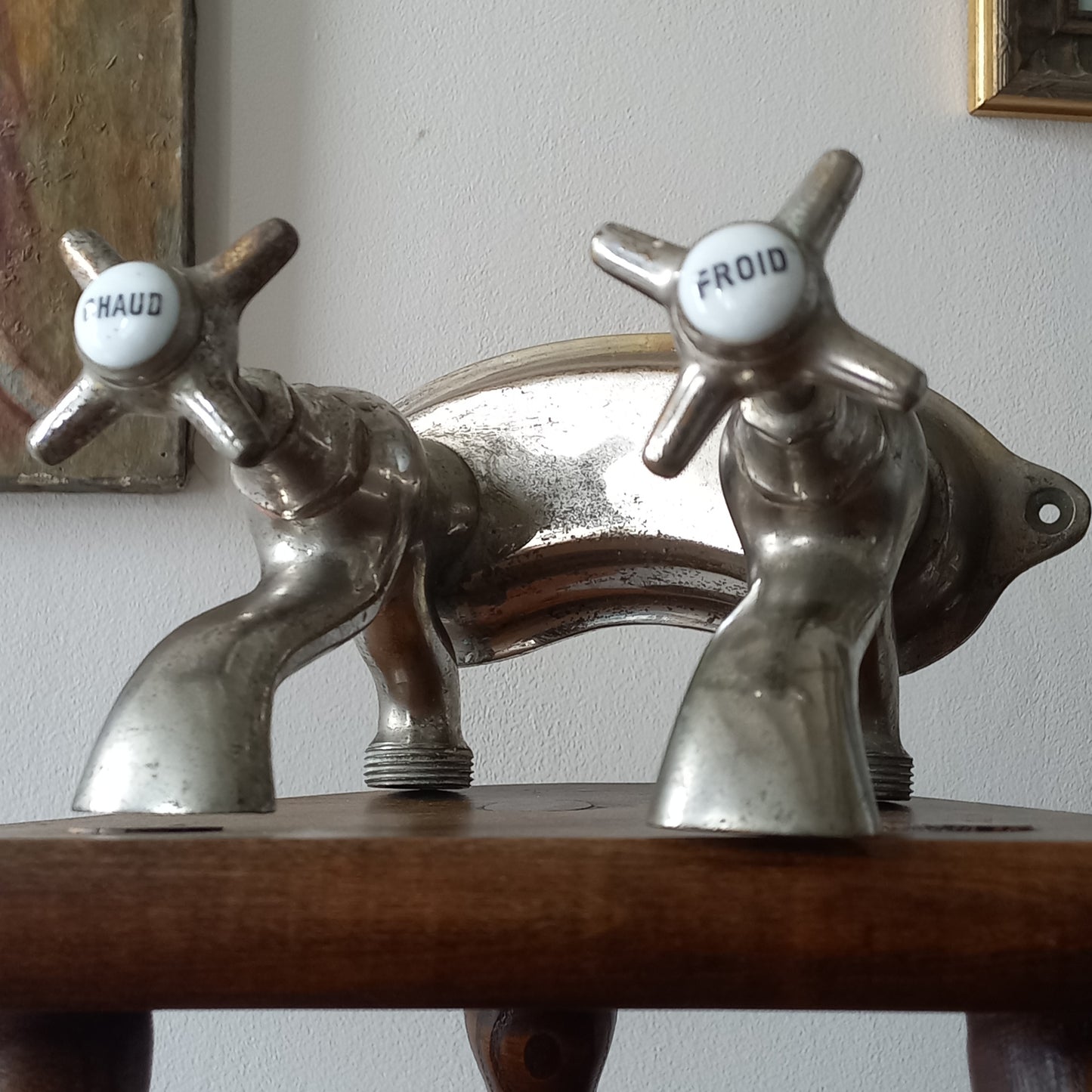 vintage metal faucet on a wooden background with visible wear and tear 