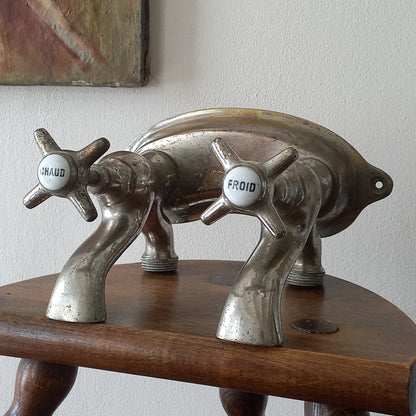 Close-up of a vintage-style faucet with wooden handle on a plain background