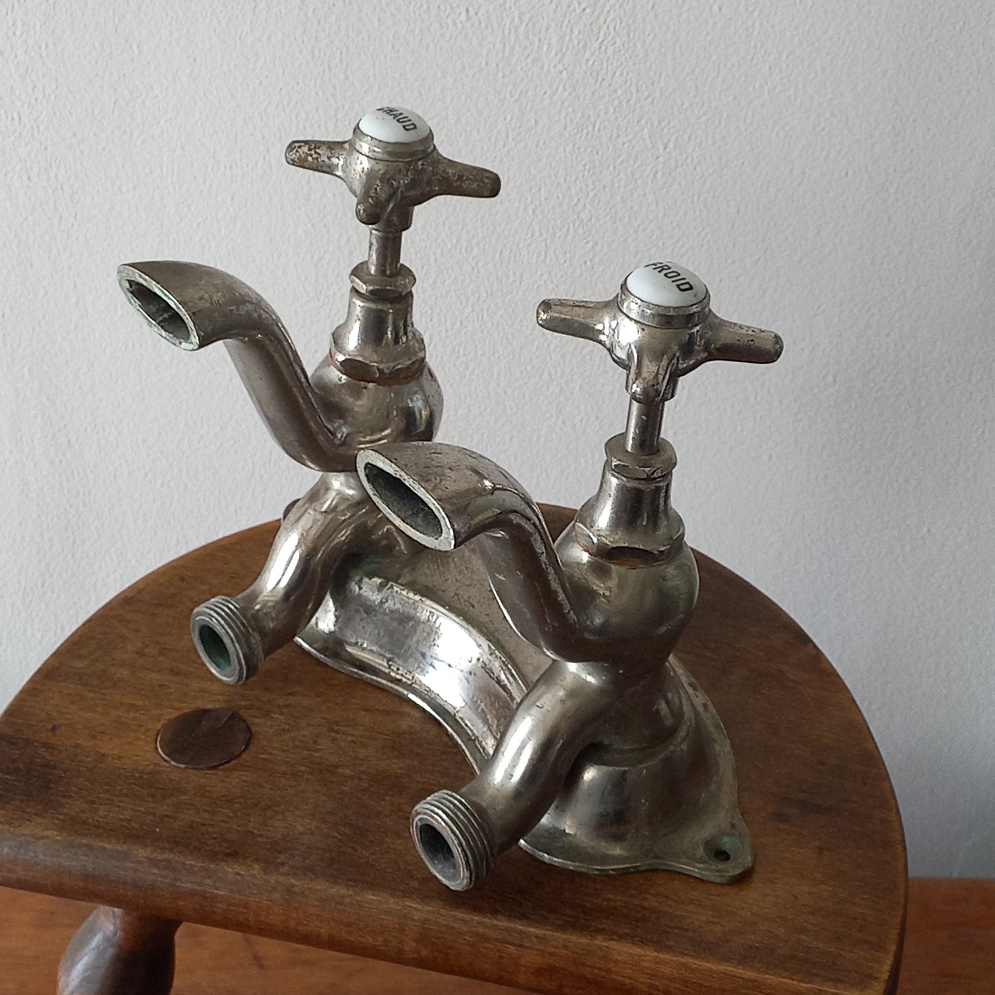 Vintage metal faucet on a wooden background
