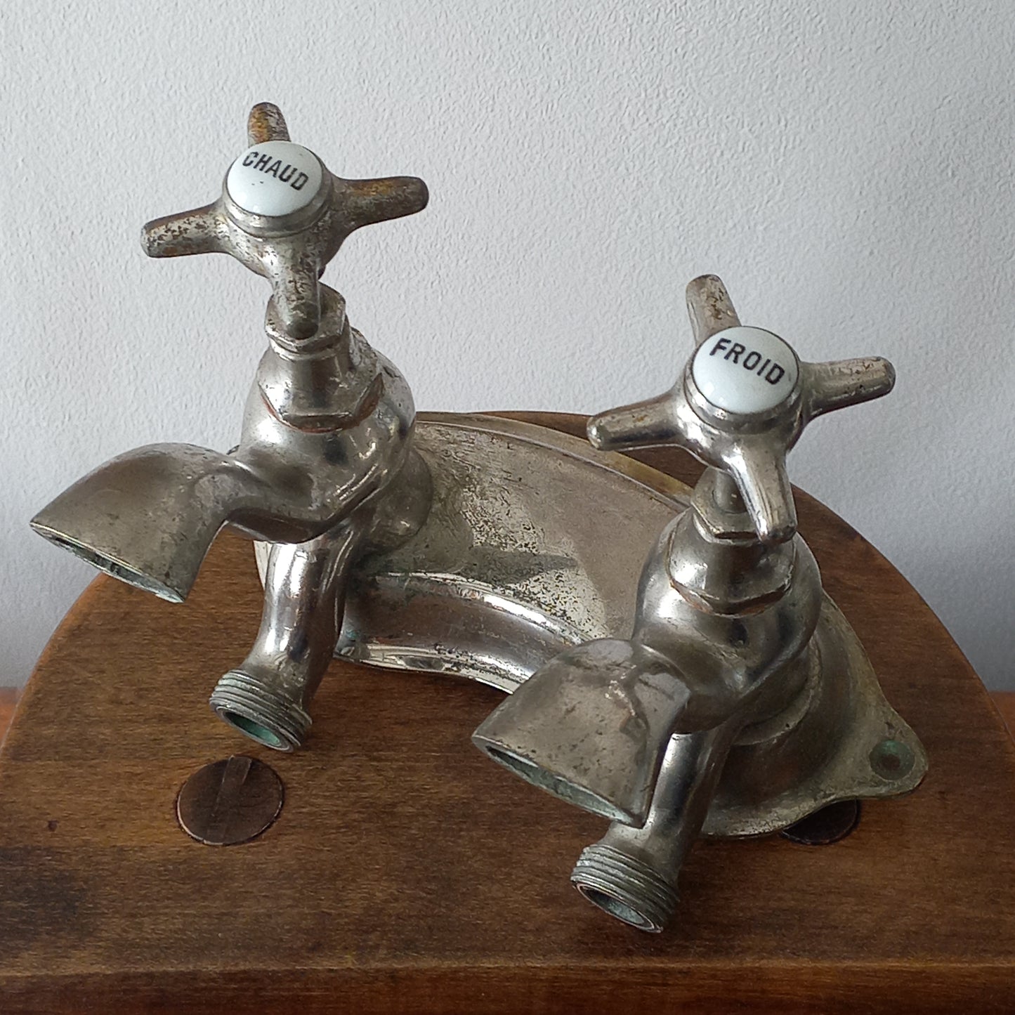 Vintage metal faucet on a wooden background