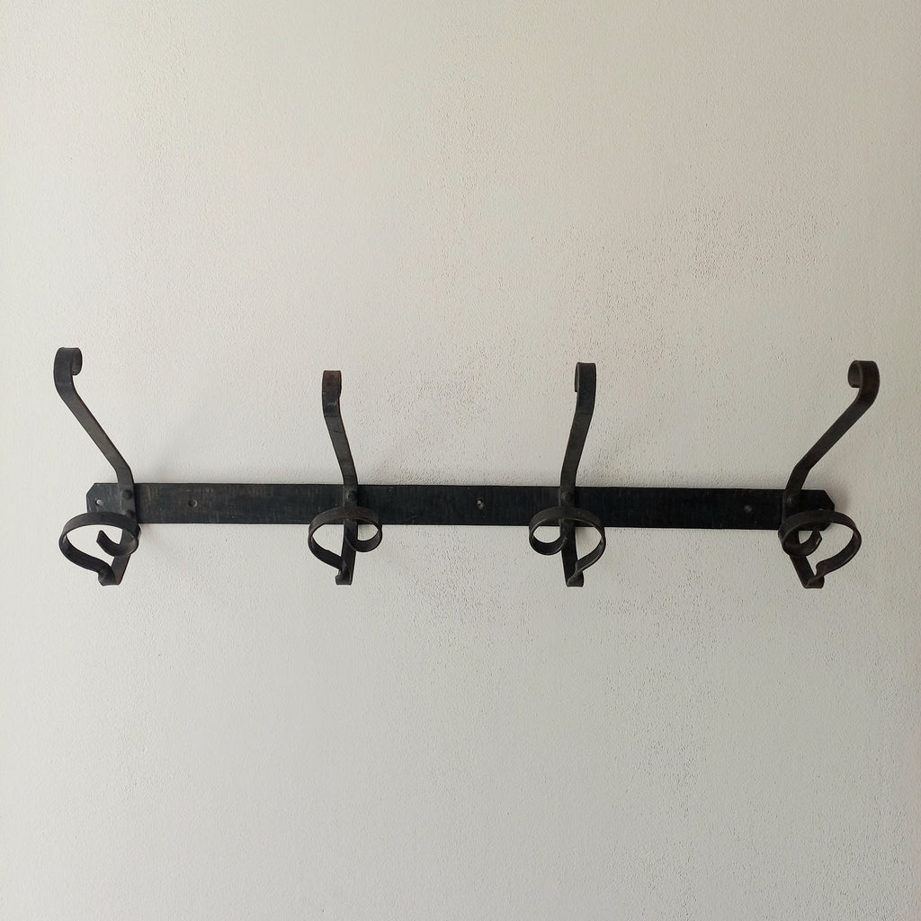A large French vintage metal coat and hat rack for 4 coats and hats, a hand-made piece that is sturdy and can be screwed directly to your wall using the holes already in the wall bracket. The colour of the coat rack is a pleasing worn satin black with traces of gold showing through in places which give it a nice aged appearance.