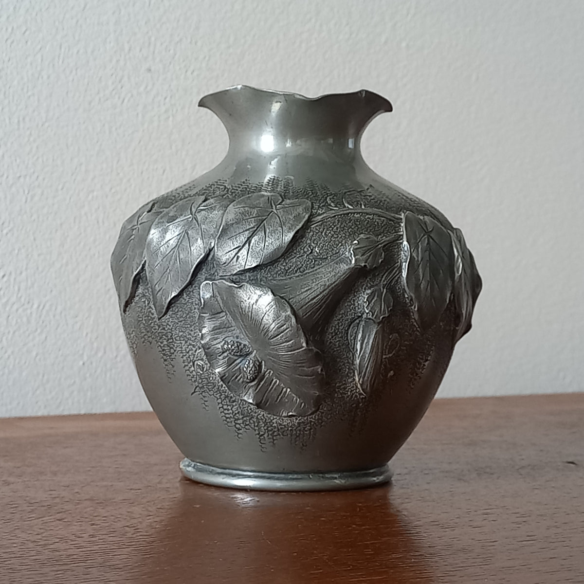 A stunning little French vintage pewter pot/vase, a highly decorative art piece with floral sculptures in relief. This beautiful little piece of art has been signed by the artist.