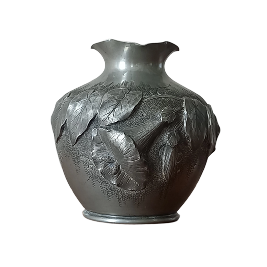 A stunning little French vintage pewter pot/vase, a highly decorative art piece with floral sculptures in relief. This beautiful little piece of art has been signed by the artist.
