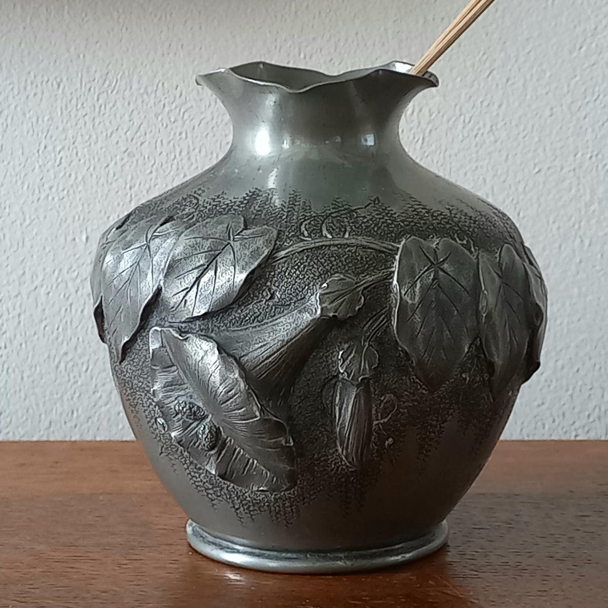 A stunning little French vintage pewter pot/vase, a highly decorative art piece with floral sculptures in relief. This beautiful little piece of art has been signed by the artist.