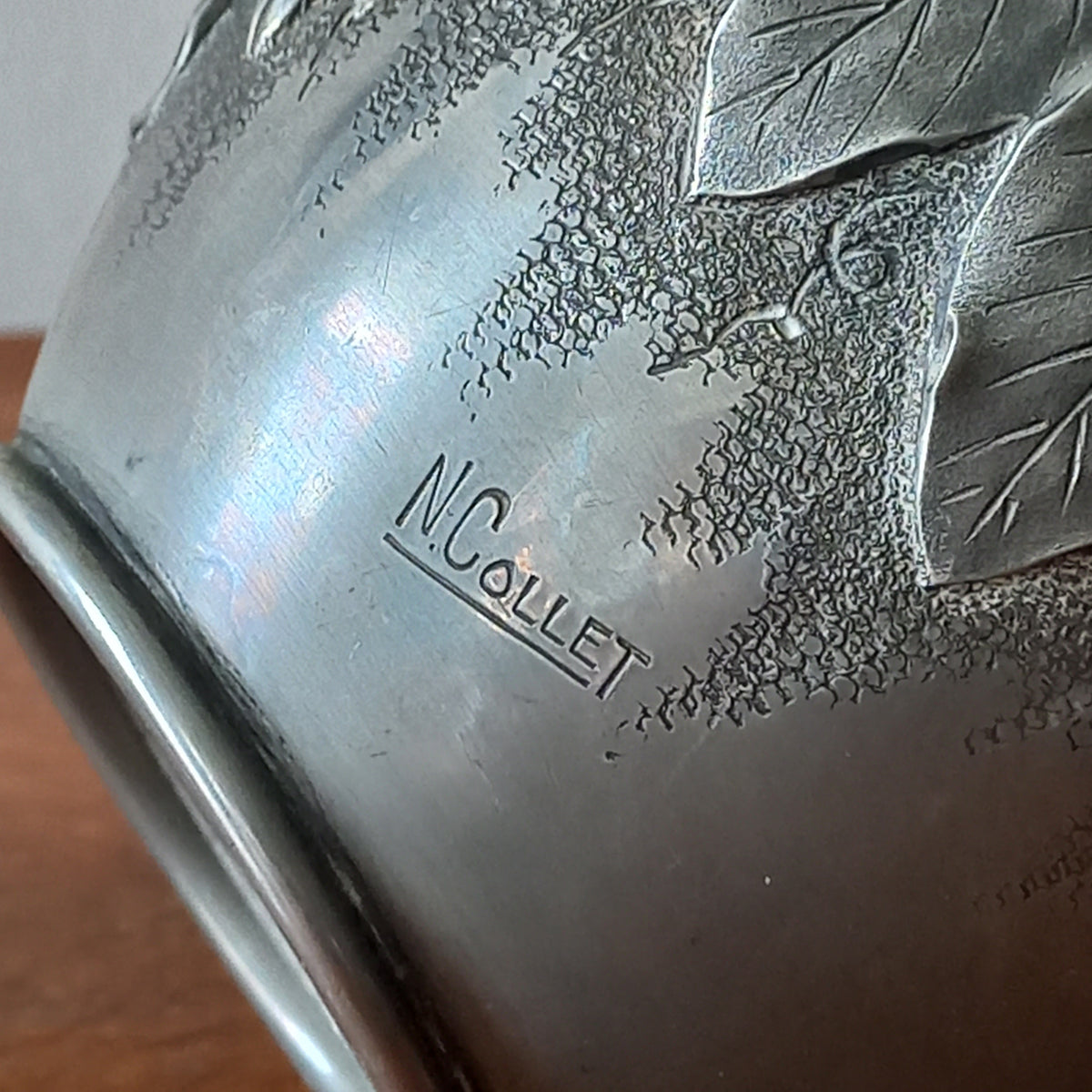 A stunning little French vintage pewter pot/vase, a highly decorative art piece with floral sculptures in relief. This beautiful little piece of art has been signed by the artist.