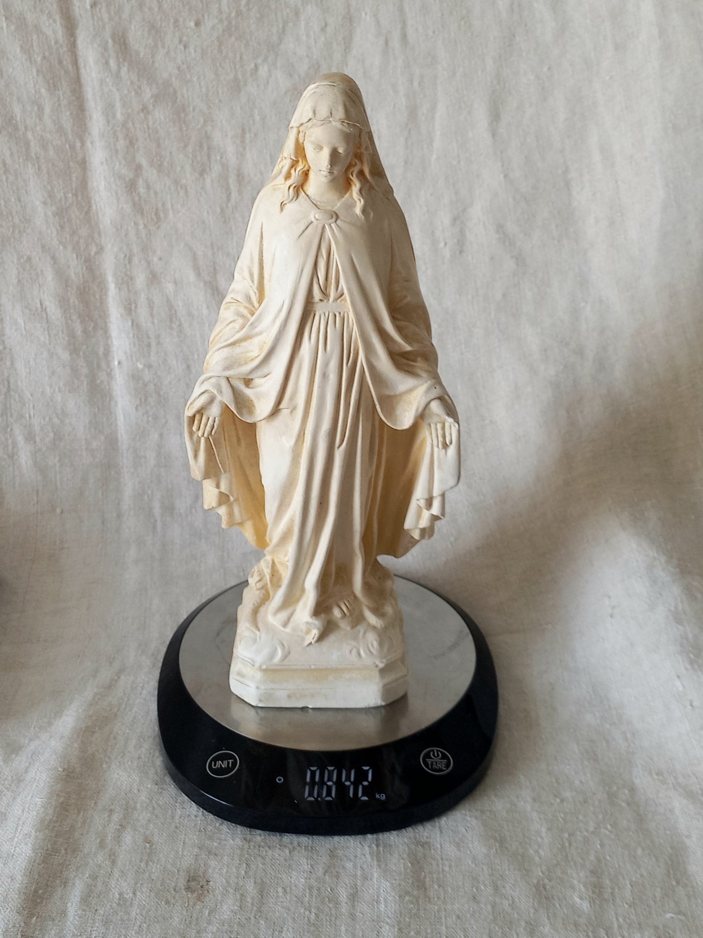 French vintage religious Madonna figurine made from plaster on digital scales for reference.