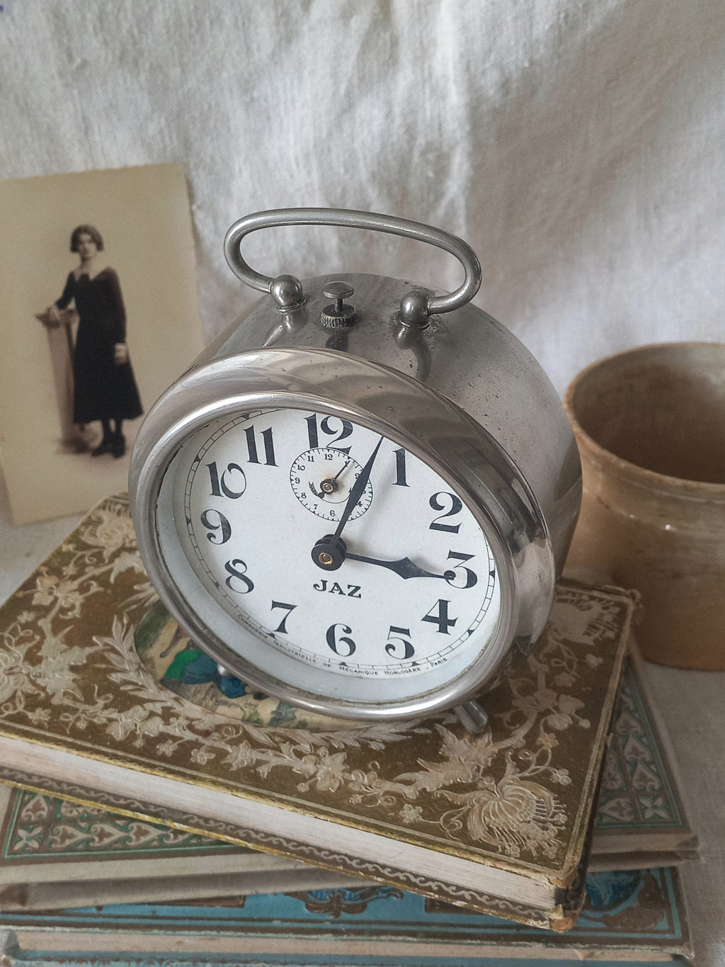 Original vintage Jaz alarm clock on books with a rustic background