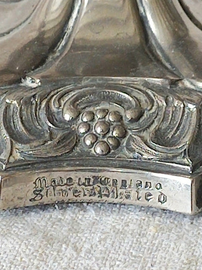 Close-up of a silver object with engraved text on a textured surface