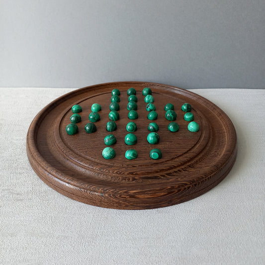 A beautiful French vintage solitaire board game with hand made hardwood base and 33 semi precious malachite stone marbles. This lovely old game also makes a wonderful piece of home decor.