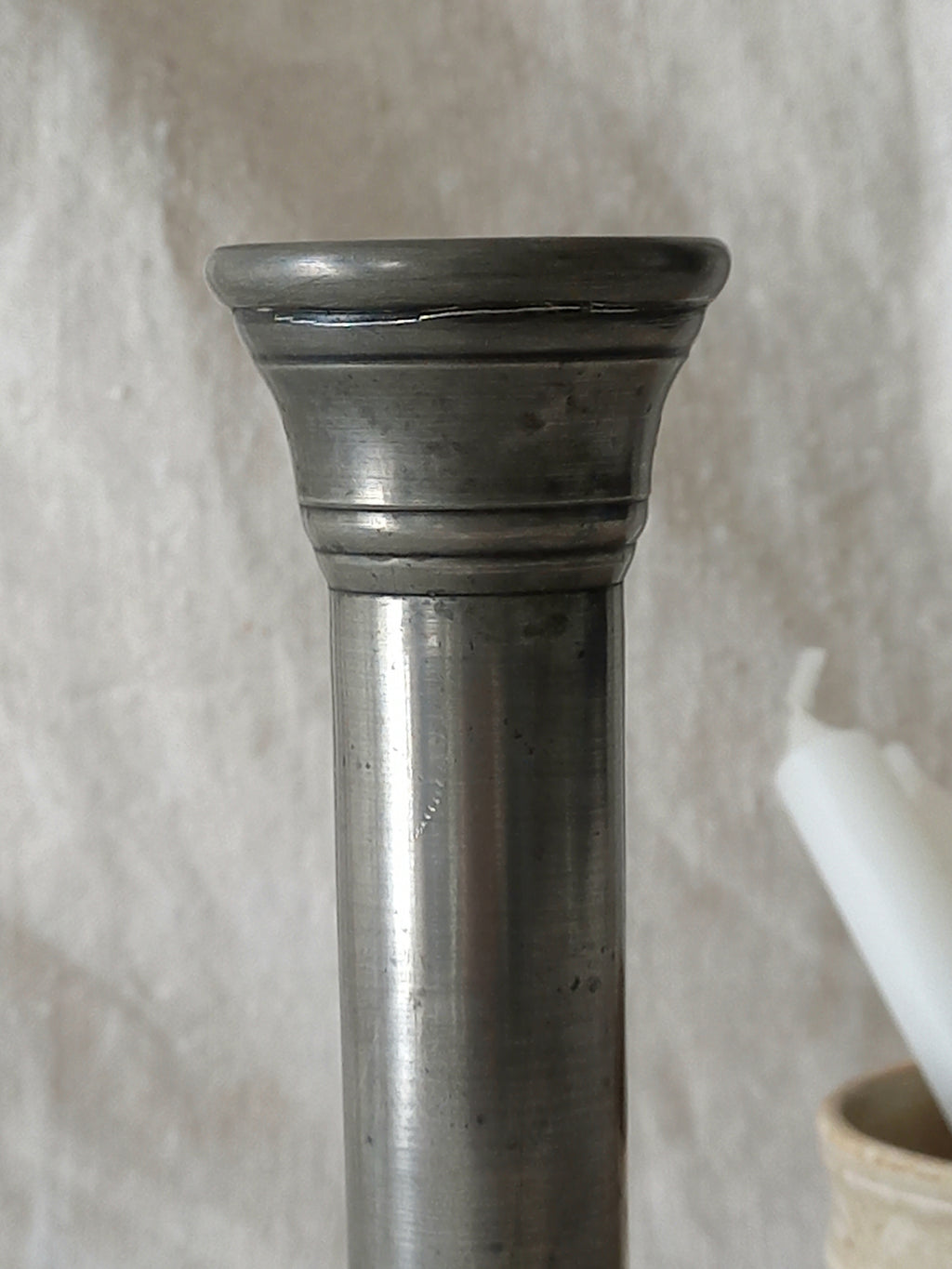 top of a pewter candle stick holder