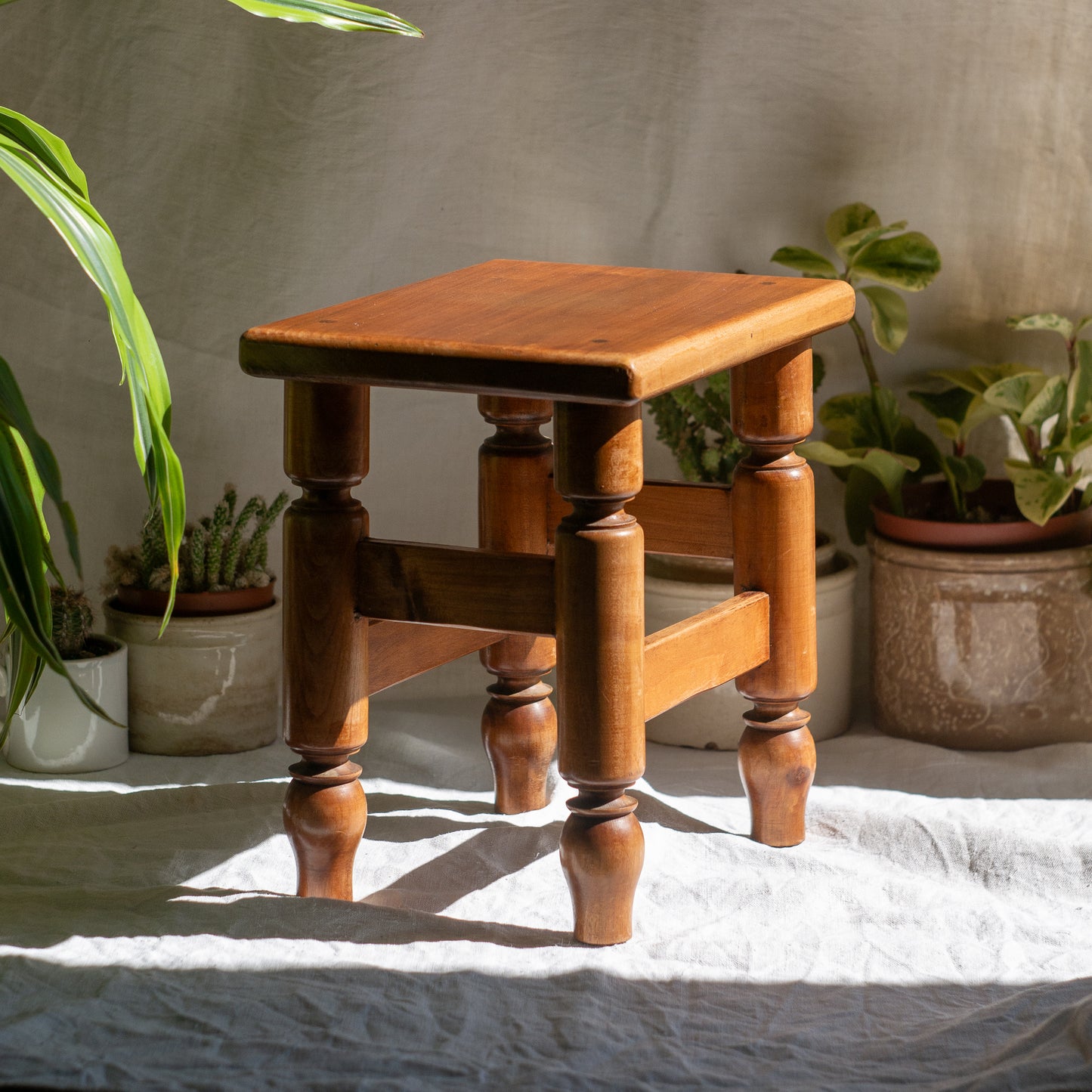 A handsome vintage French wooden stool in a lovely shade of honey-coloured brown. This old stool is very solid and would make a great plant stand (we currently use one on our desk as a plant stand and it looks great!) and many other decorative possibilities.