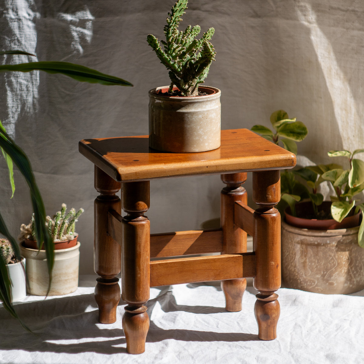 A handsome vintage French wooden stool in a lovely shade of honey-coloured brown. This old stool is very solid and would make a great plant stand (we currently use one on our desk as a plant stand and it looks great!) and many other decorative possibilities.