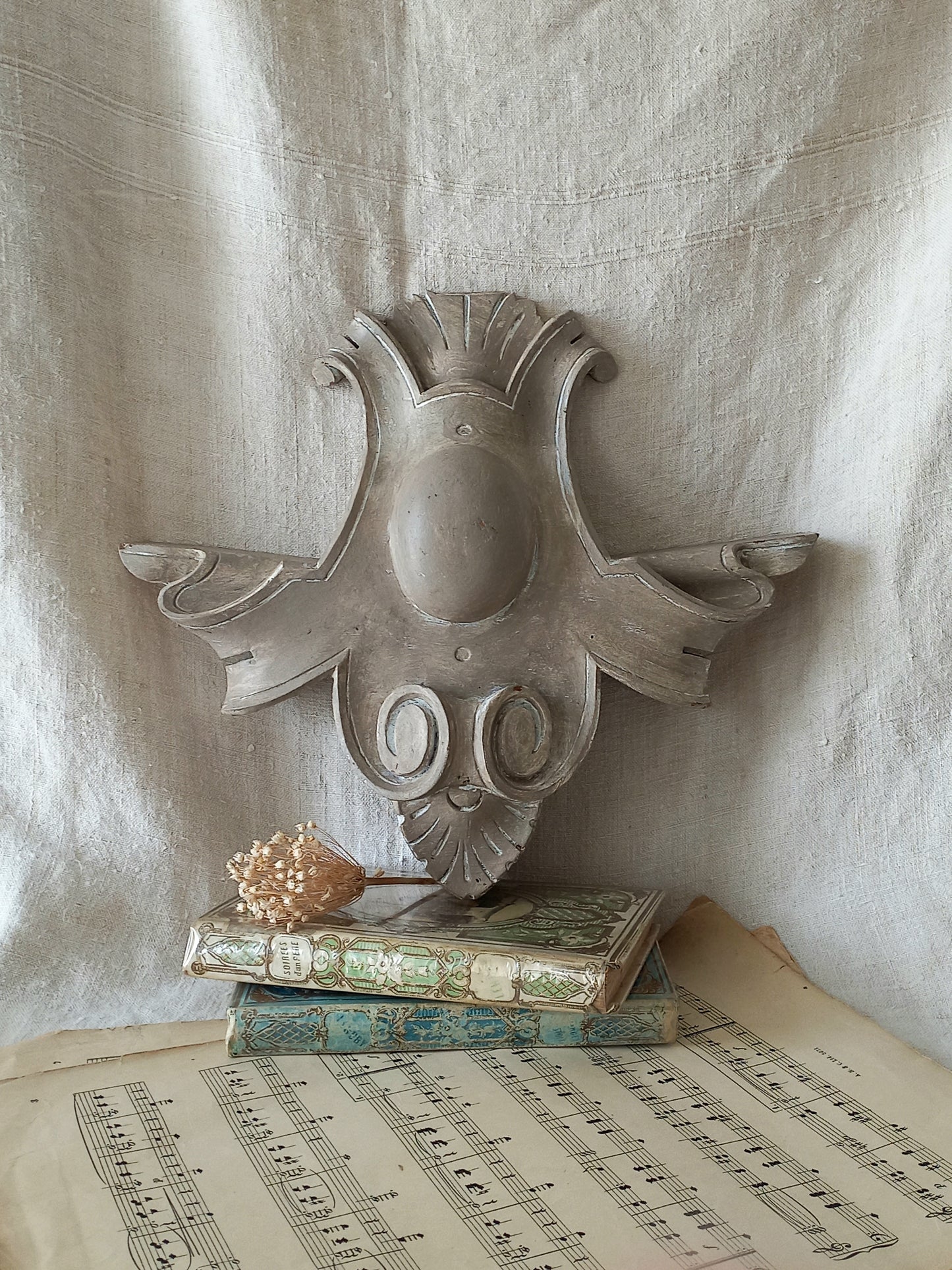 A French antique decorative carved wooden pediment that has been tastefully painted and worn to give an attractive shabby chic finish.