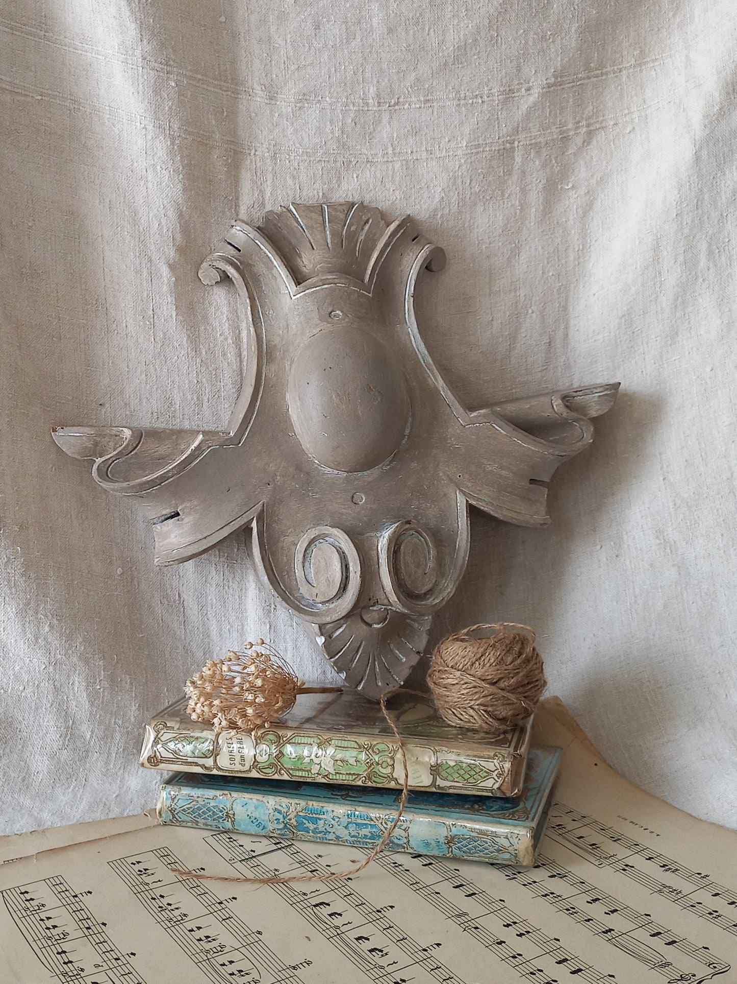 A French antique decorative carved wooden pediment that has been tastefully painted and worn to give an attractive shabby chic finish.
