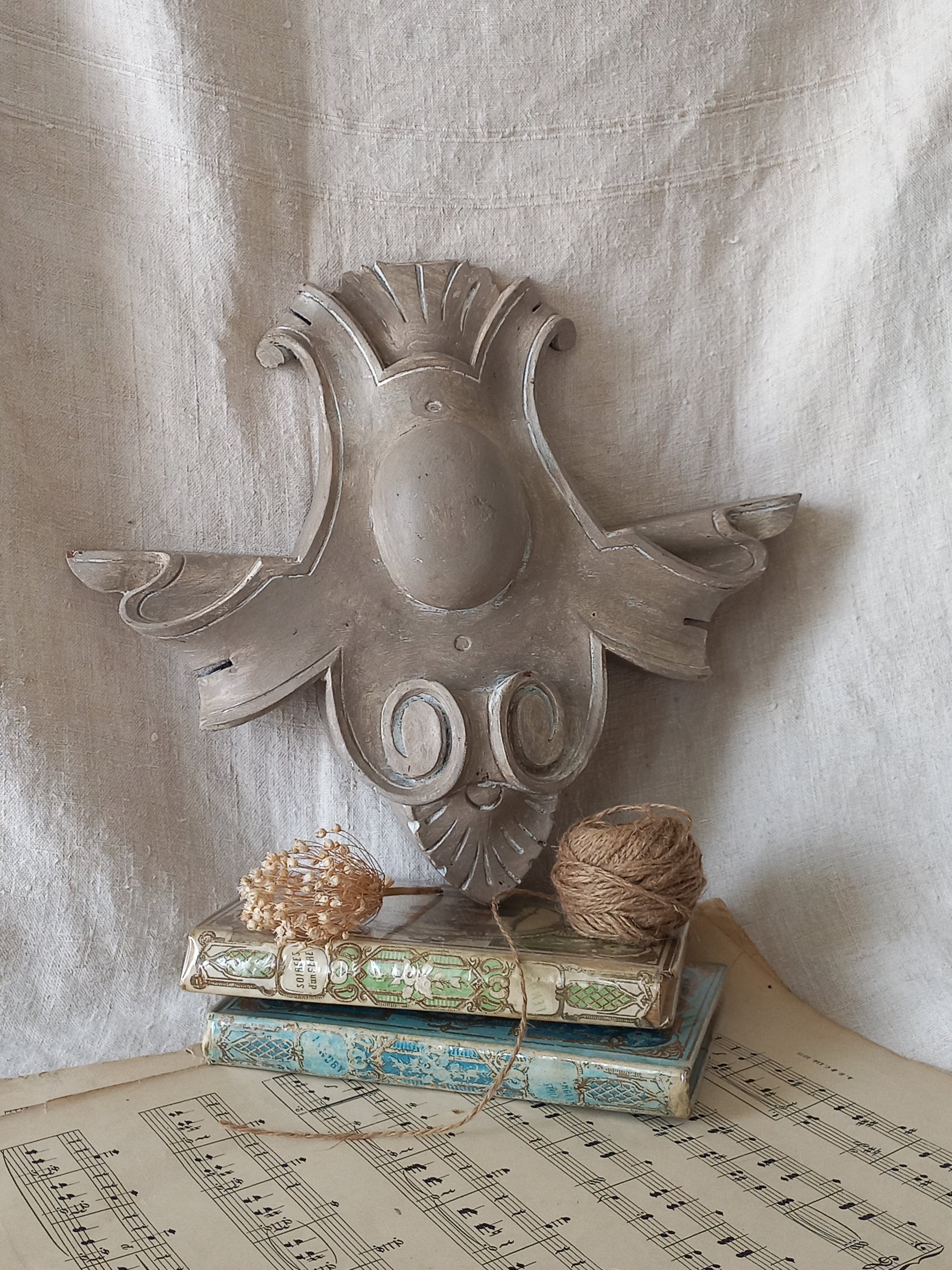 A French antique decorative carved wooden pediment that has been tastefully painted and worn to give an attractive shabby chic finish.
