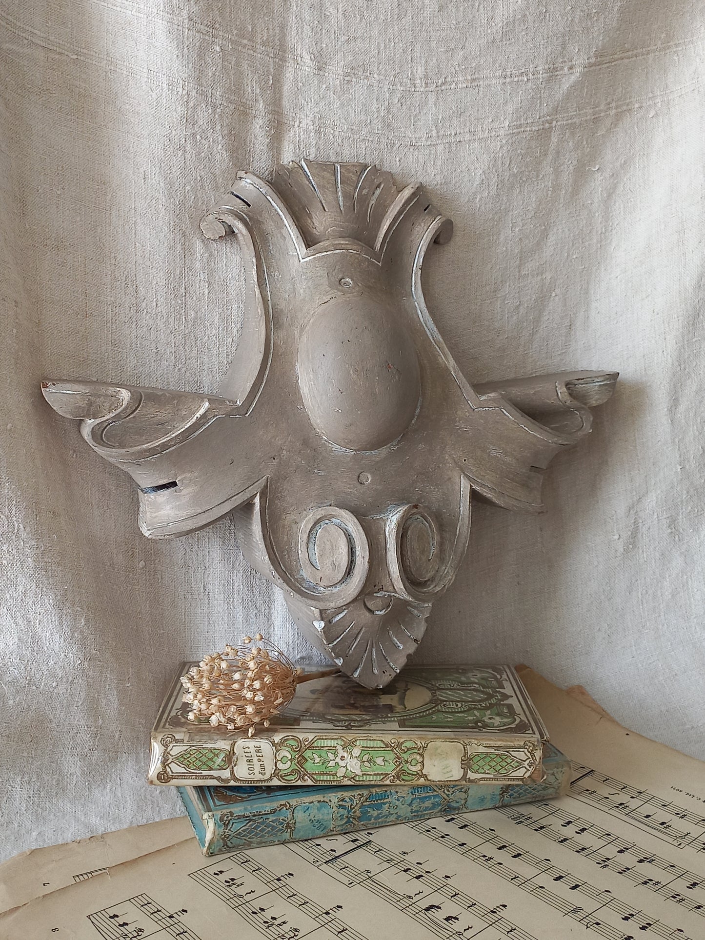 A French antique decorative carved wooden pediment that has been tastefully painted and worn to give an attractive shabby chic finish.