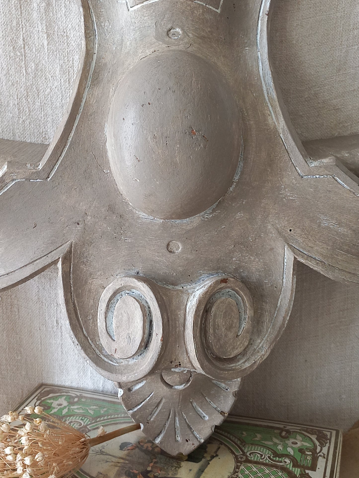 A French antique decorative carved wooden pediment that has been tastefully painted and worn to give an attractive shabby chic finish.