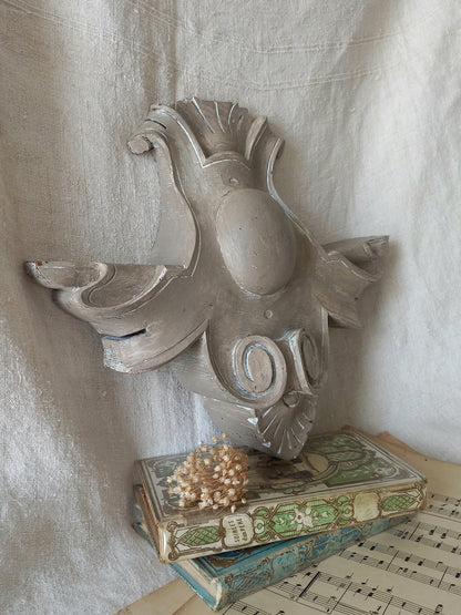 A French antique decorative carved wooden pediment that has been tastefully painted and worn to give an attractive shabby chic finish.